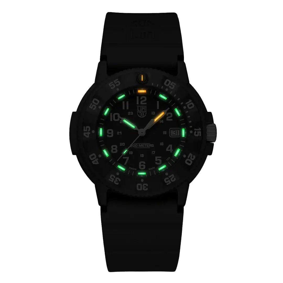 Luminox Navy Seal 3001 Dive Watch glowing in the dark with green and orange luminescent markers for enhanced night visibility.
