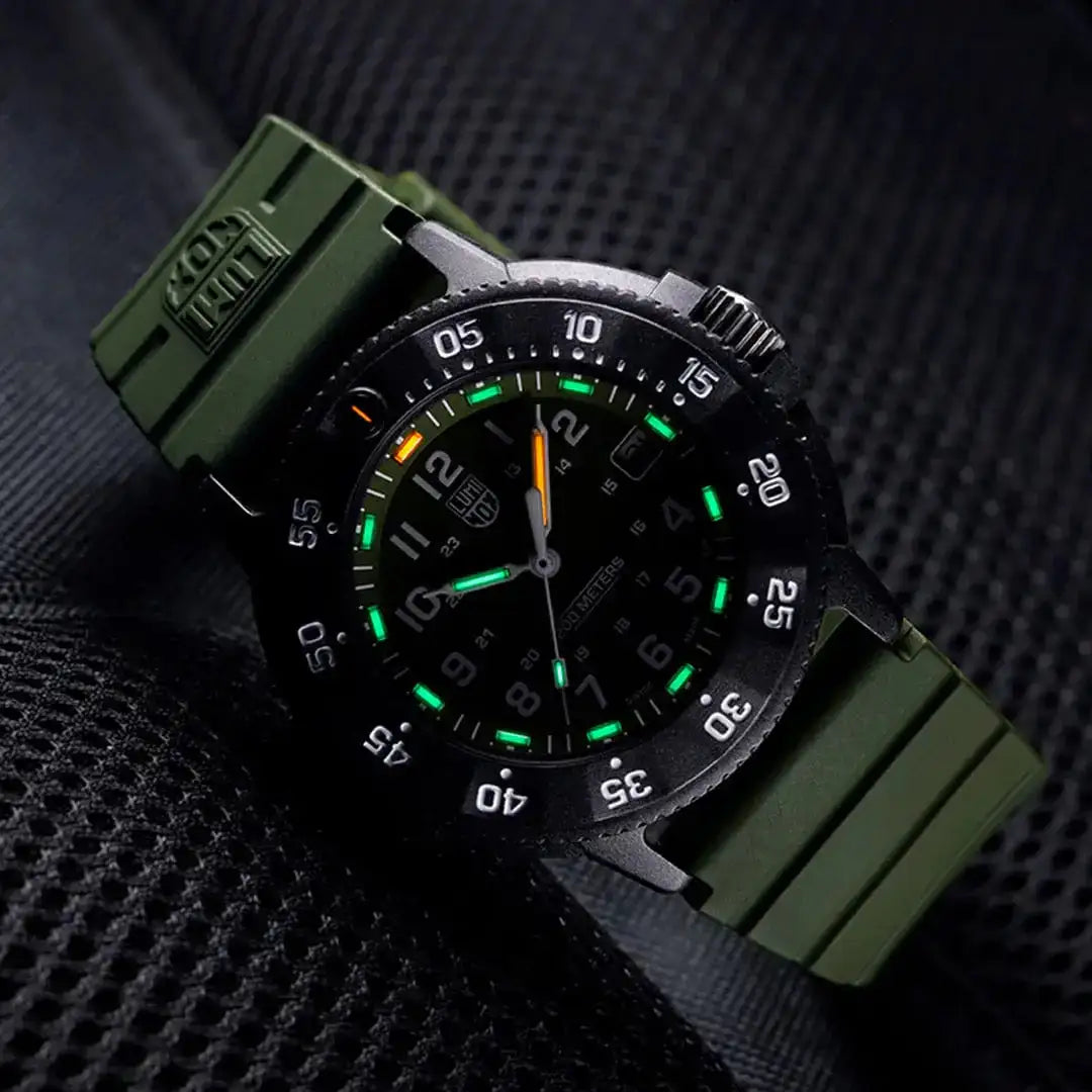 Angled view of Luminox Navy Seal 3001 Dive Watch glowing in the dark, emphasizing its tactical style and luminous markers.  from  John Bull Clothing 