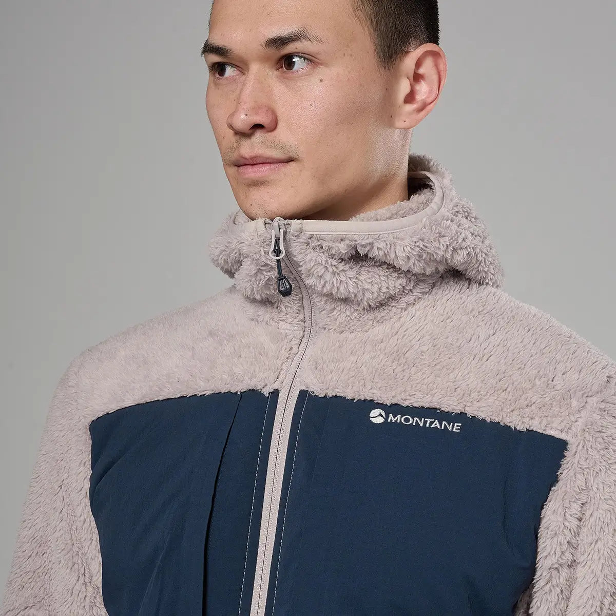 Close-up of a male model wearing a beige fleece jacket with a high collar and full zip, showcasing the soft, textured fleece material for warmth - SKU: JB1618-MO-S