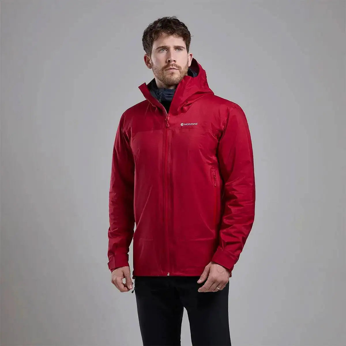 Model wearing Montane Mens Cetus Lite Waterproof Jacket in red, highlighting its ergonomic fit and protective outer shell for outdoor activities.  from  John Bull Clothing 
