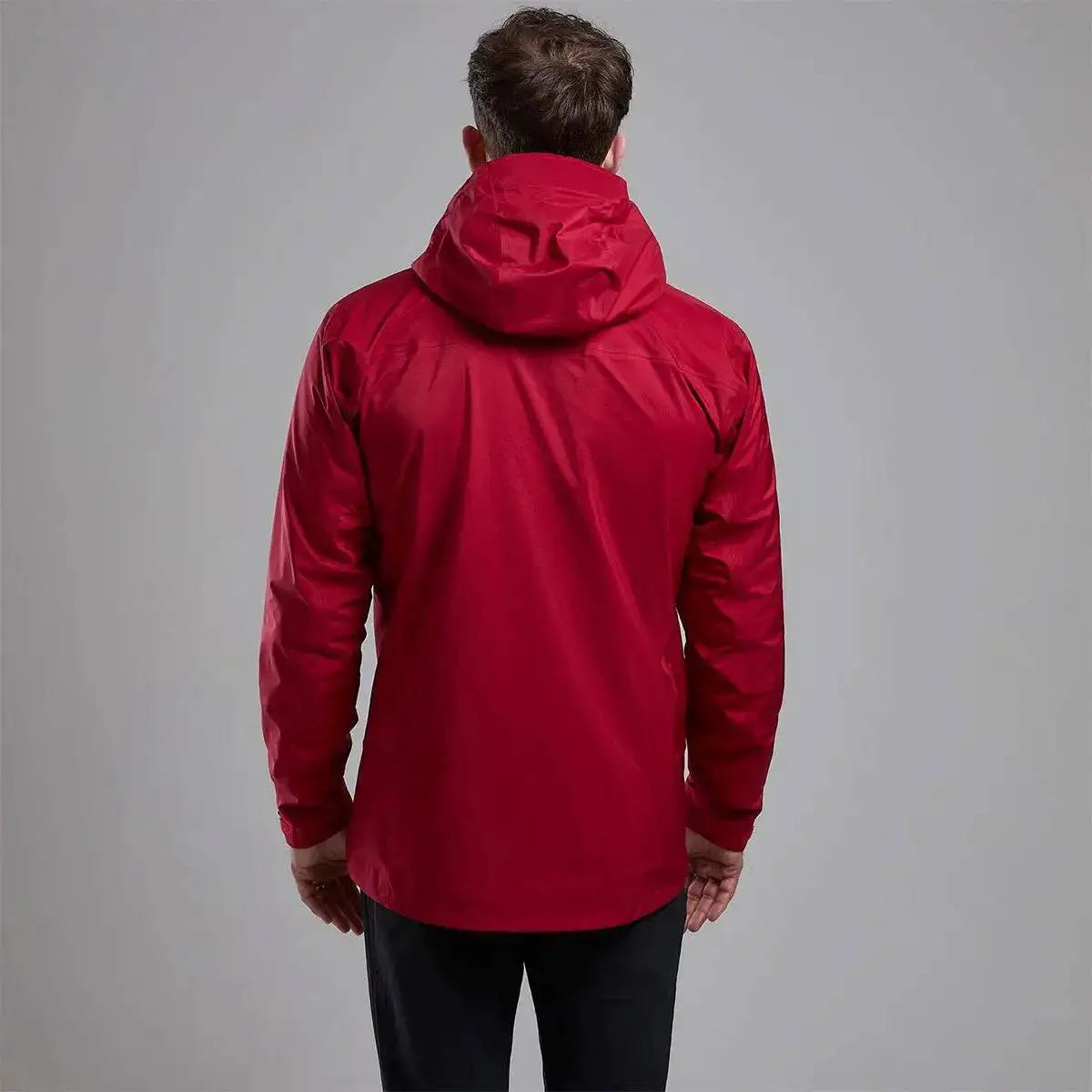 Back view of Montane Mens Cetus Lite Waterproof Jacket in red, highlighting the ergonomic fit and protective hood for full coverage in wet conditions.  from  John Bull Clothing 
