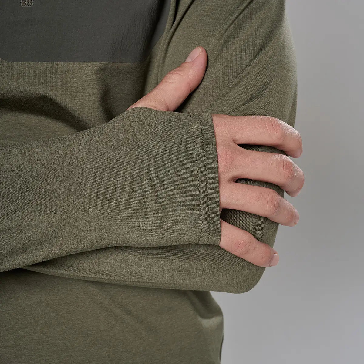 Back view of male model in olive green outdoor jacket with attached hood, showing durable fabric and seam details