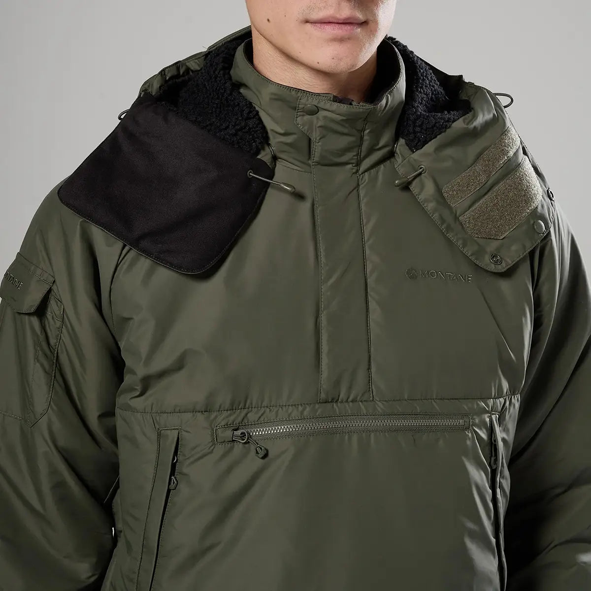 Montane Extreme Smock Insulated Mens jacket with hood partially opened to reveal fleece lining, designed for cold climates, John Bull Clothing.
