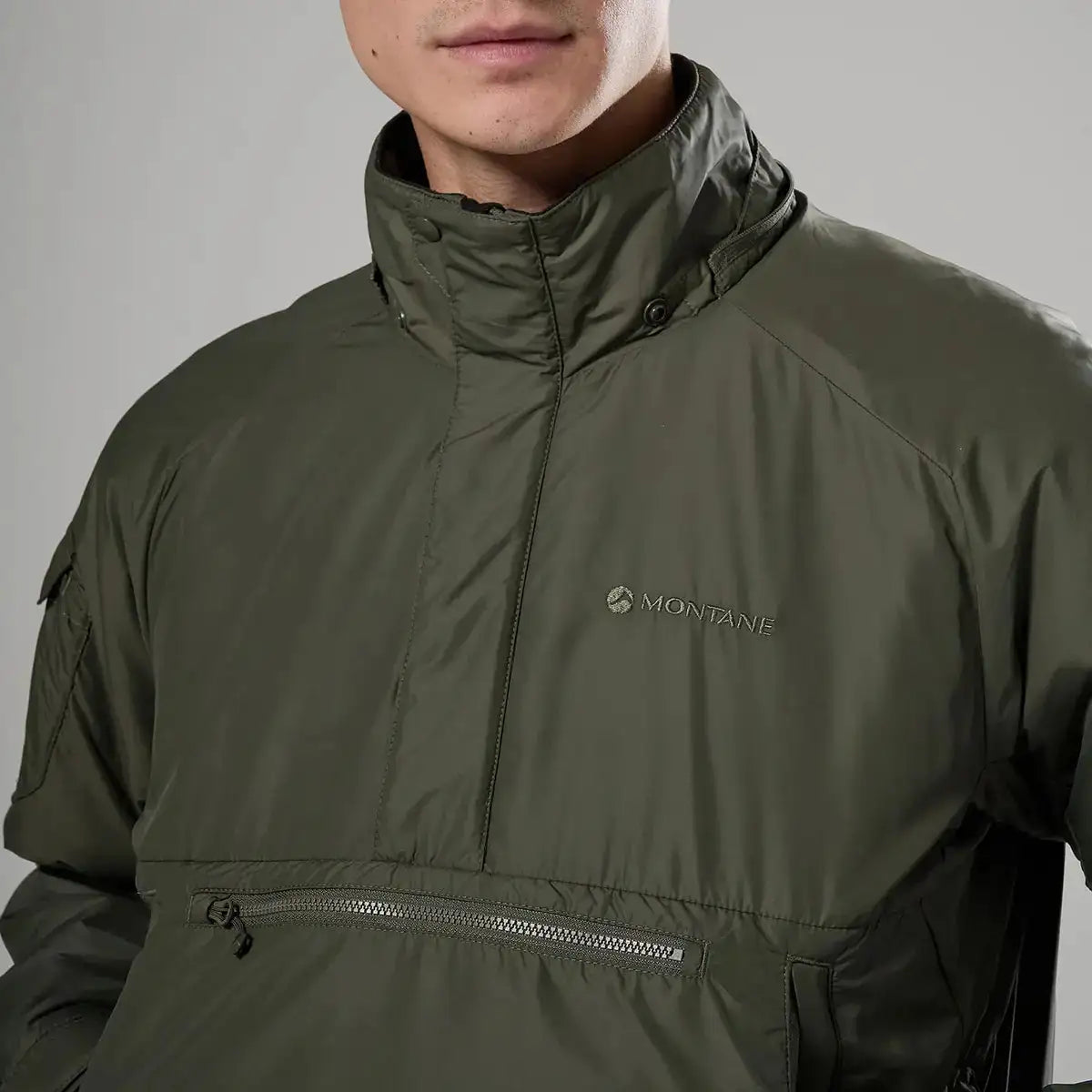 Chest detail of Montane Extreme Smock Insulated Mens jacket in olive, highlighting logo and zippered pocket, exclusive at John Bull Clothing.  from  John Bull Clothing 