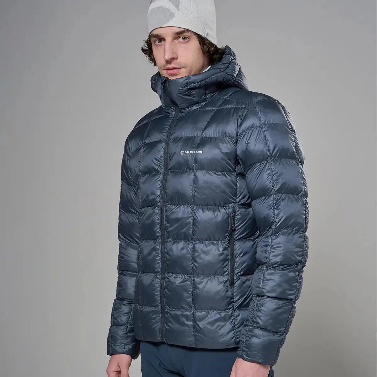 Montane Mens Icarus 3.0 Hooded Insulated Jacket in navy blue, lightweight puffer style with zippered pockets and high collar, ideal for outdoor activities.