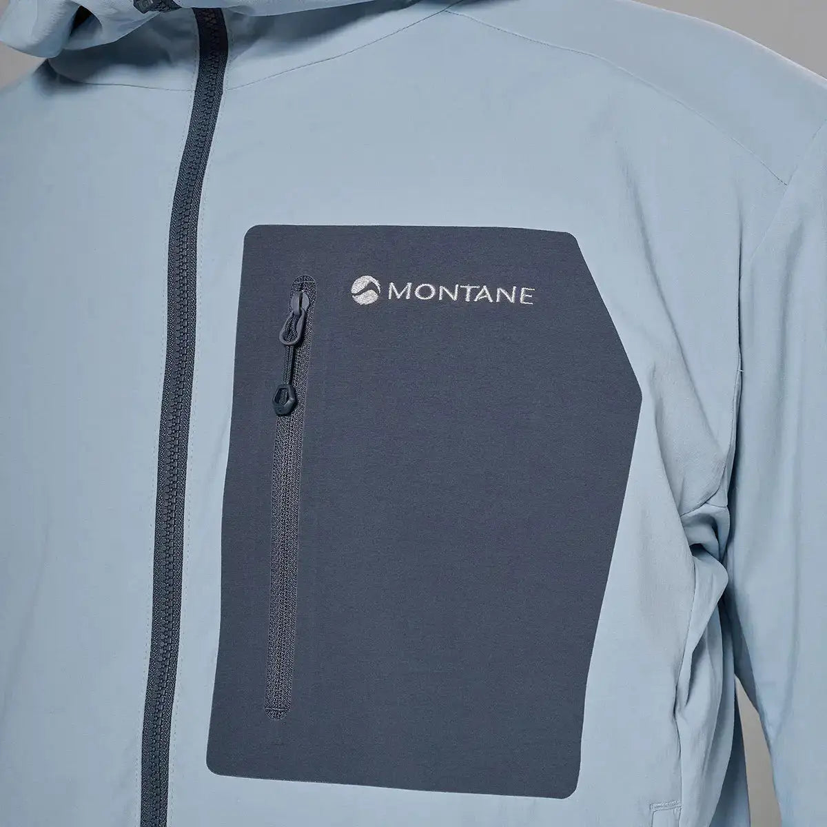 Close-up of jacket's chest pocket with zip, light gray softshell jacket with Montane logo, technical outdoor clothing, SKU: JB1617-MS-S