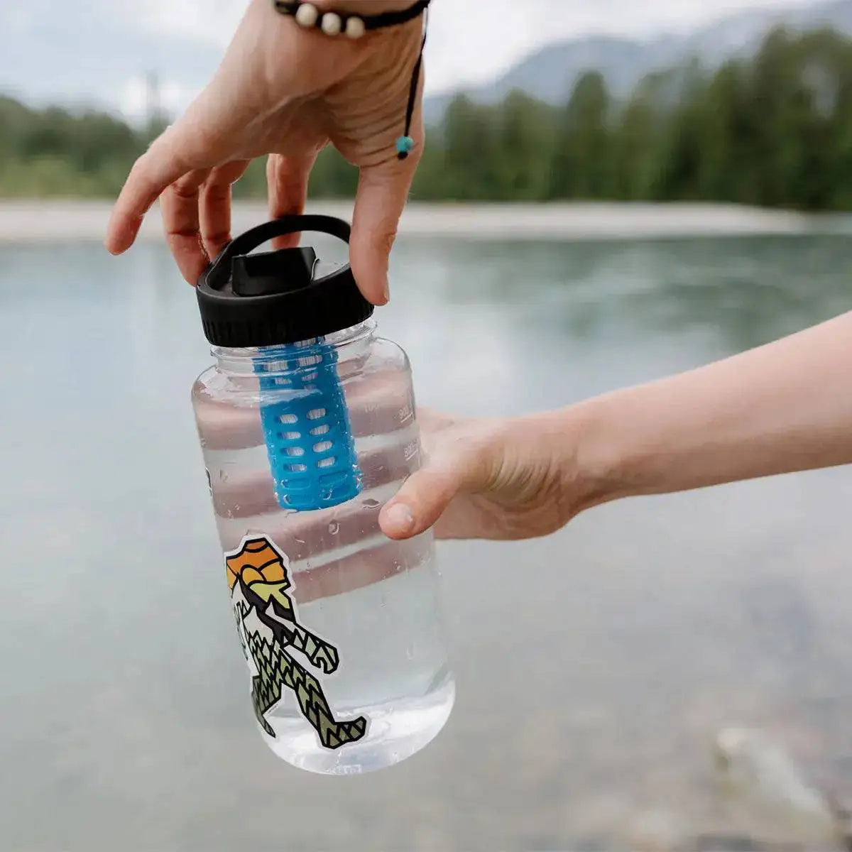 Person using Platypus DayCap In Water Bottle Filter in a natural outdoor setting, ensuring clean hydration during adventures.  from  John Bull Clothing 