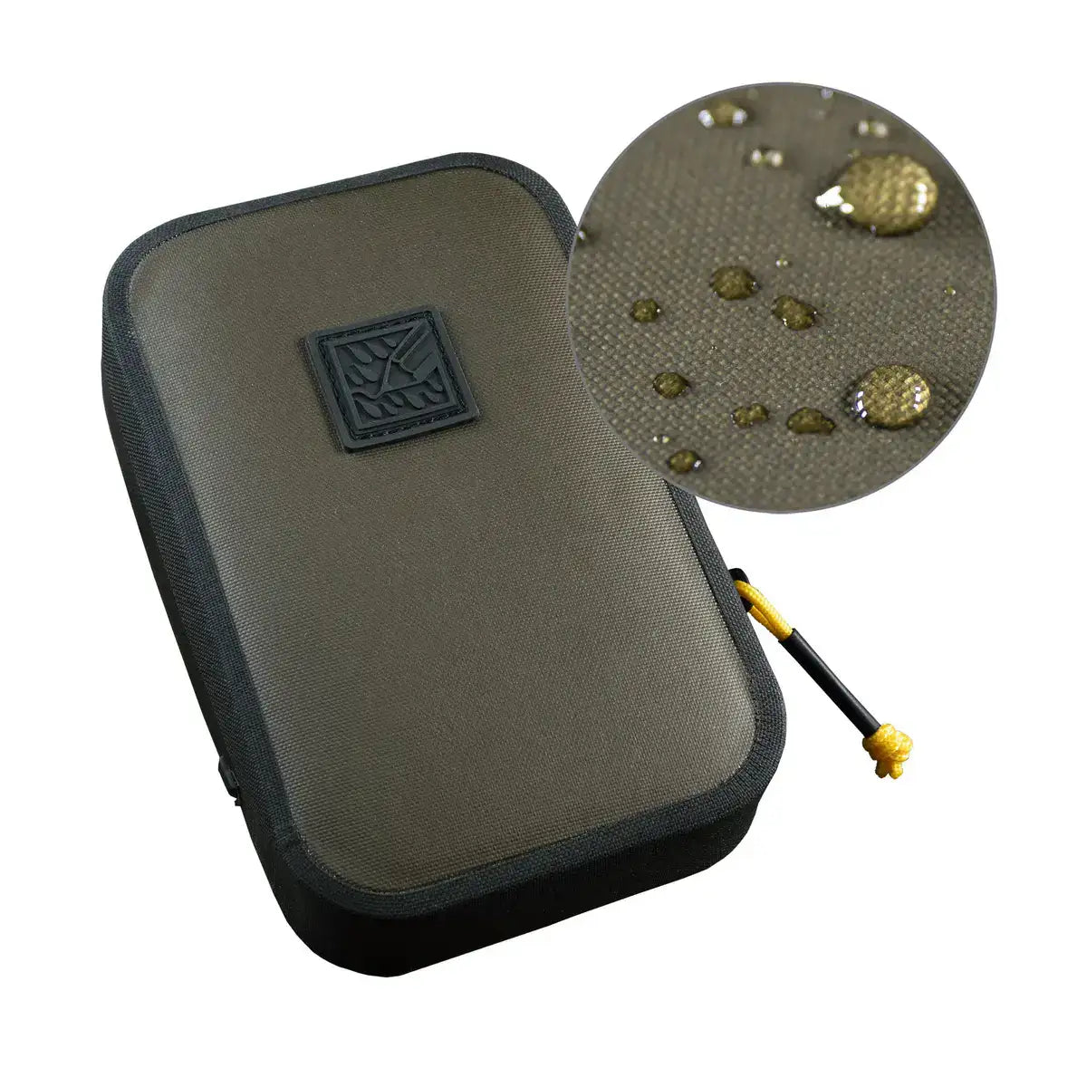 Close-up of water droplets on khaki fabric of Rite in the Rain waterproof rain shadow pouch with black zipper and yellow cord, on wooden background