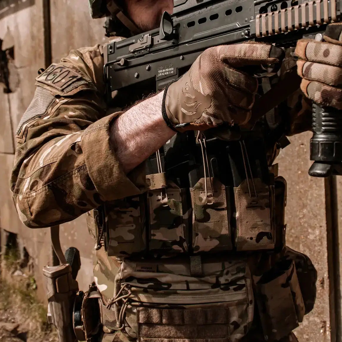 Operator wearing Spectre Quad Elastic Magazine Pouch MTP during tactical training, demonstrating quick-access magazine storage in multicam gear setup.  from  John Bull Clothing 
