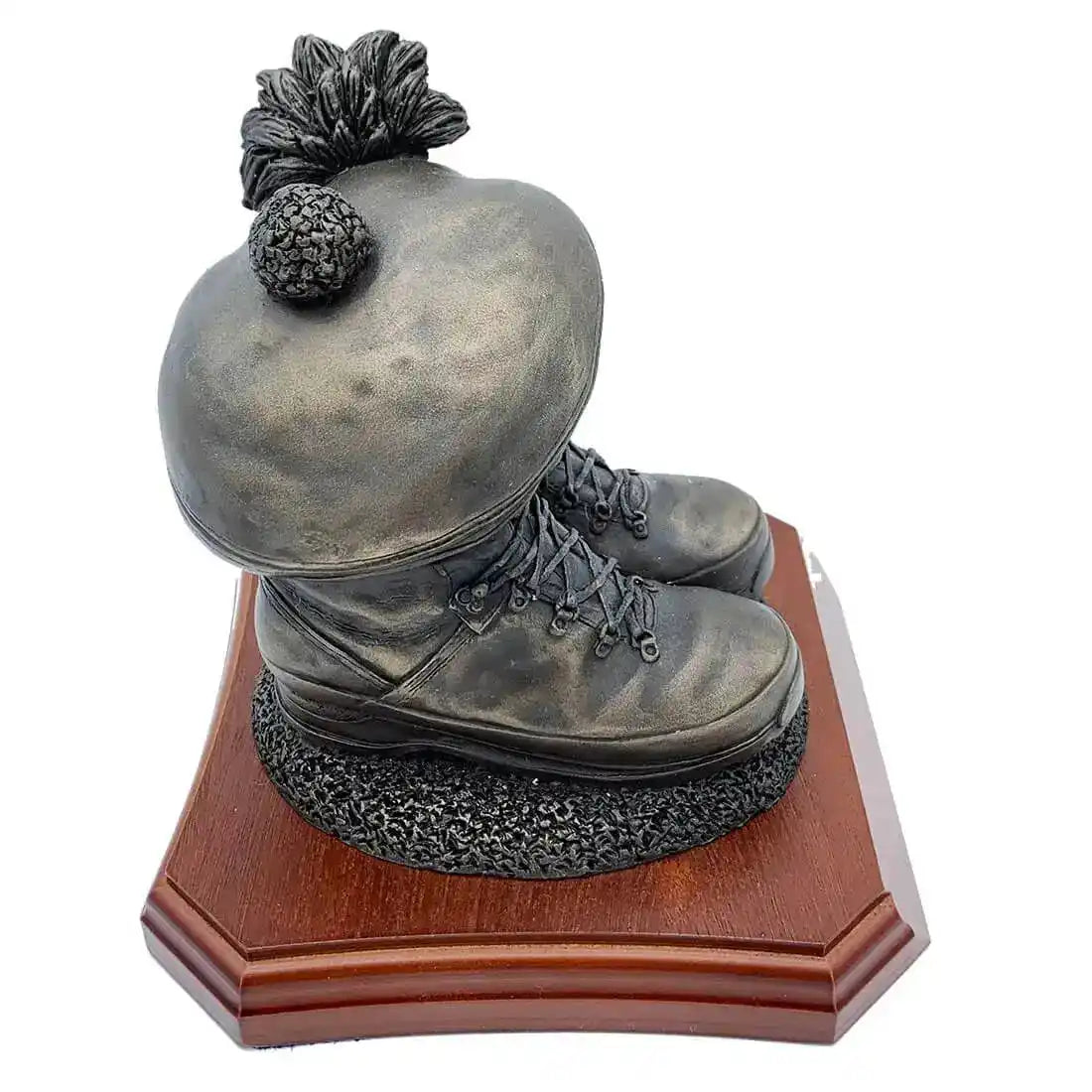 Angled view of Boots and Tam O'Shanter Statue on wooden base, showcasing lifelike military boots and Scottish cap. Perfect for military memorabilia collectors.  from  John Bull Clothing 