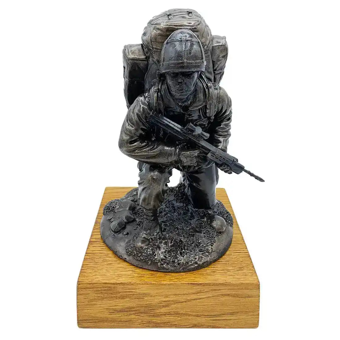 Bronze Resin Kneeling Combat Statue with Helmet by John Bulls on oak base, featuring soldier with SA80 rifle and Bergen backpack in detailed finish.  from  John Bull Clothing 