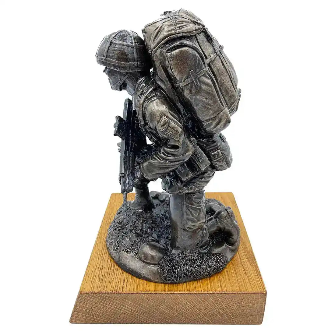 Side view of Bronze Resin Kneeling Combat Statue with Helmet, showing military gear and SA80 rifle on solid oak base for home and garden decor.  from  John Bull Clothing 