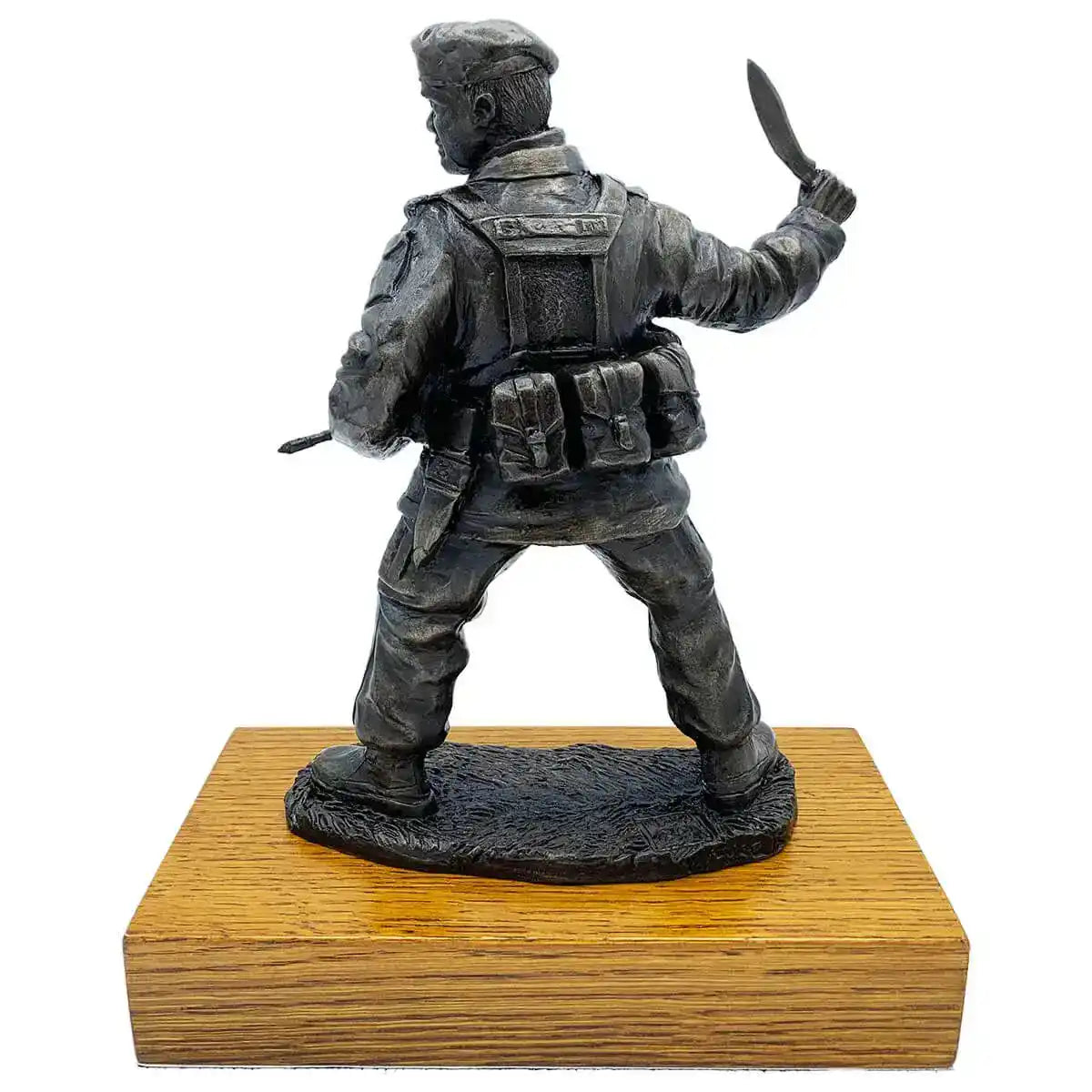 Rear view of Gurkha with Kukri bronze resin statue highlighting backpack and gear, mounted on a polished wooden base for elegant presentation.  from  John Bull Clothing 