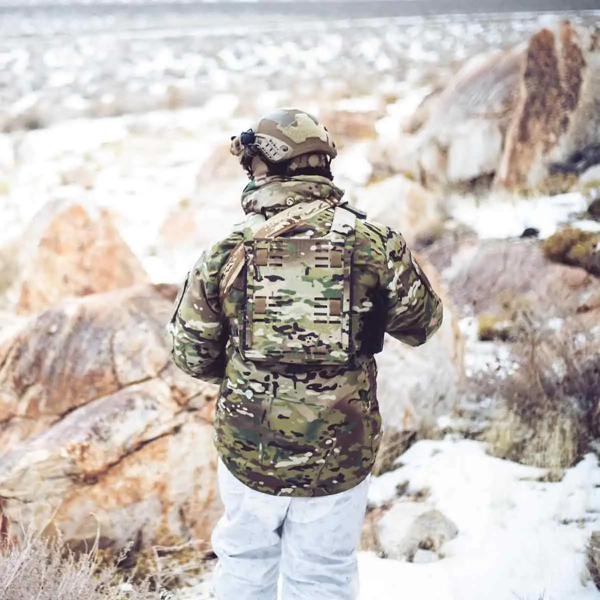 Person wearing the Keela Mk5 Waterproof Jacket MTC in a snowy outdoor environment, demonstrating its rugged and weather-resistant design.  from  John Bull Clothing 