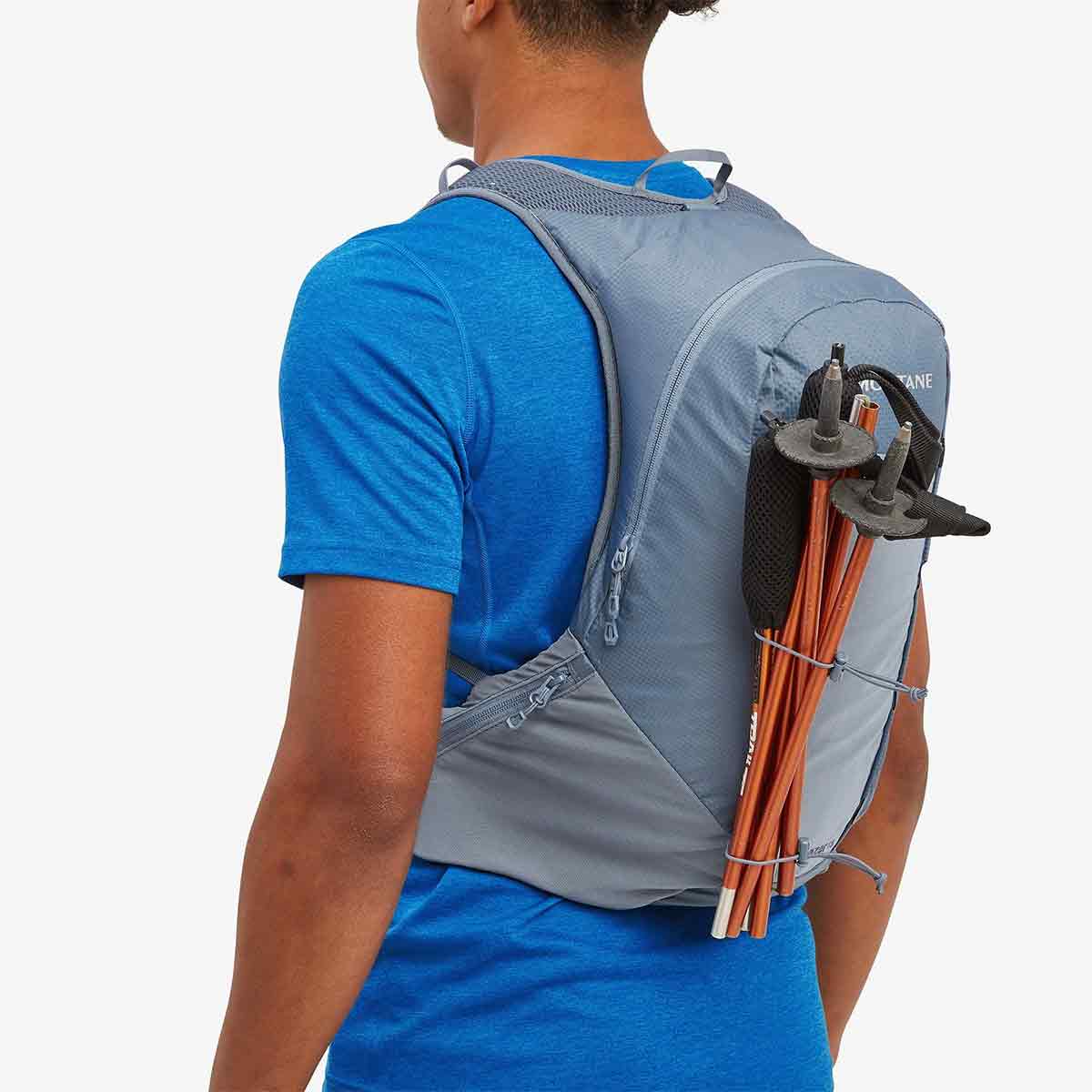 Montane Trailblazer 18L Backpack with trekking poles attached, highlighting its versatile storage options for outdoor gear.