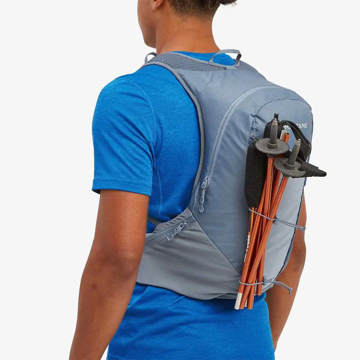 Montane Trailblazer 18L Backpack with trekking poles attached, highlighting its versatile storage options for outdoor gear.  from  John Bull Clothing 