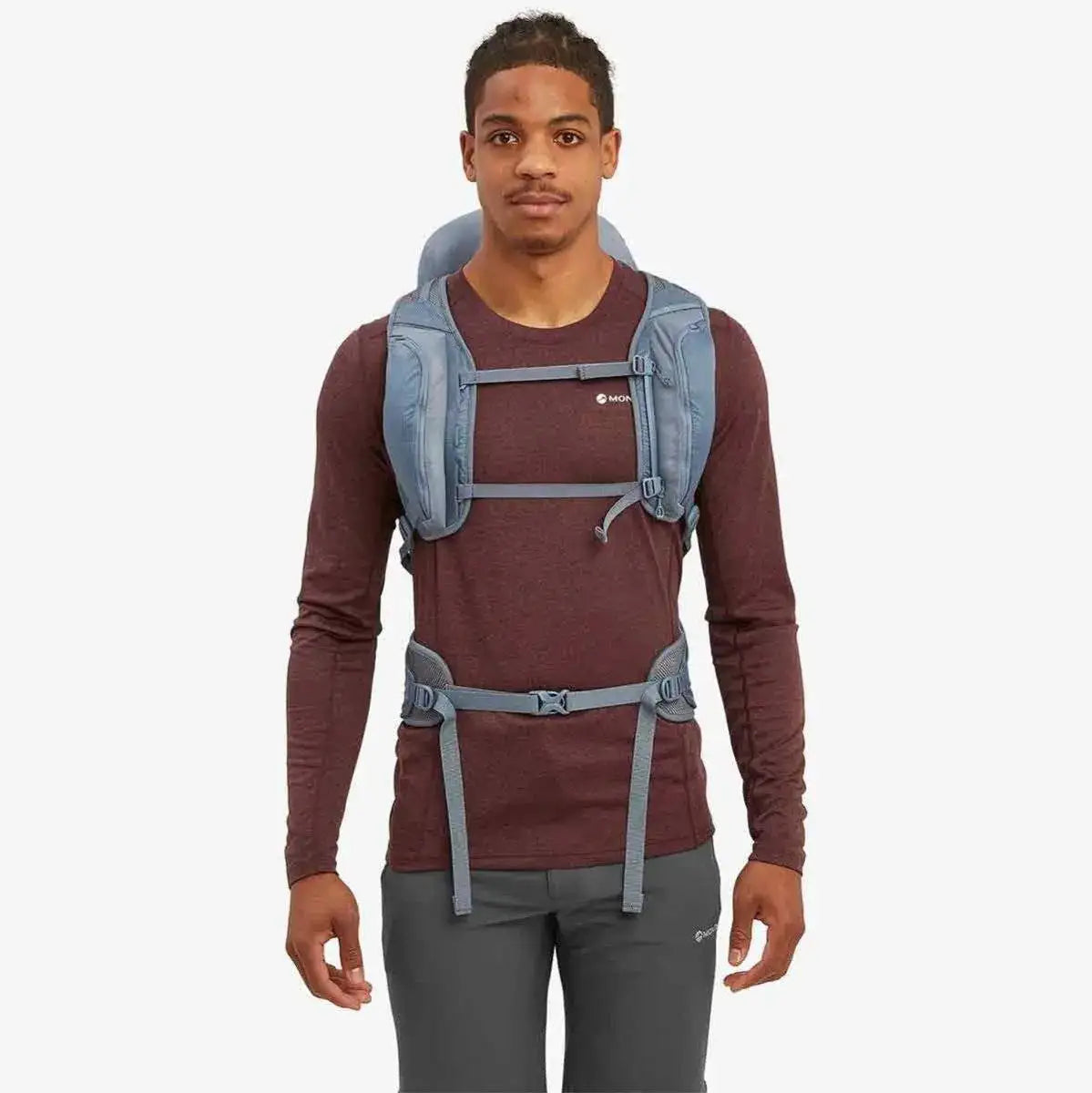 Model wearing the Montane Trailblazer 32 Litre Backpack in blue, highlighting the adjustable chest and waist straps for a secure and comfortable fit.  from  John Bull Clothing 