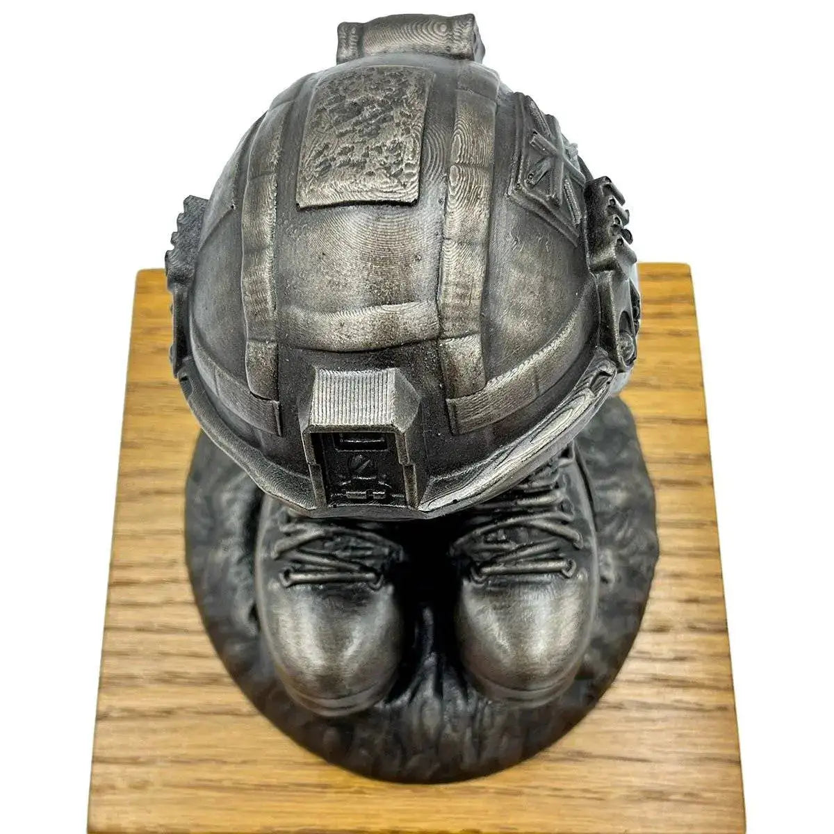 Top view of Helmet and Boots Statue Bronze Resin showing detailed helmet design and boot placement on textured base for home or office display.  from  John Bull Clothing 