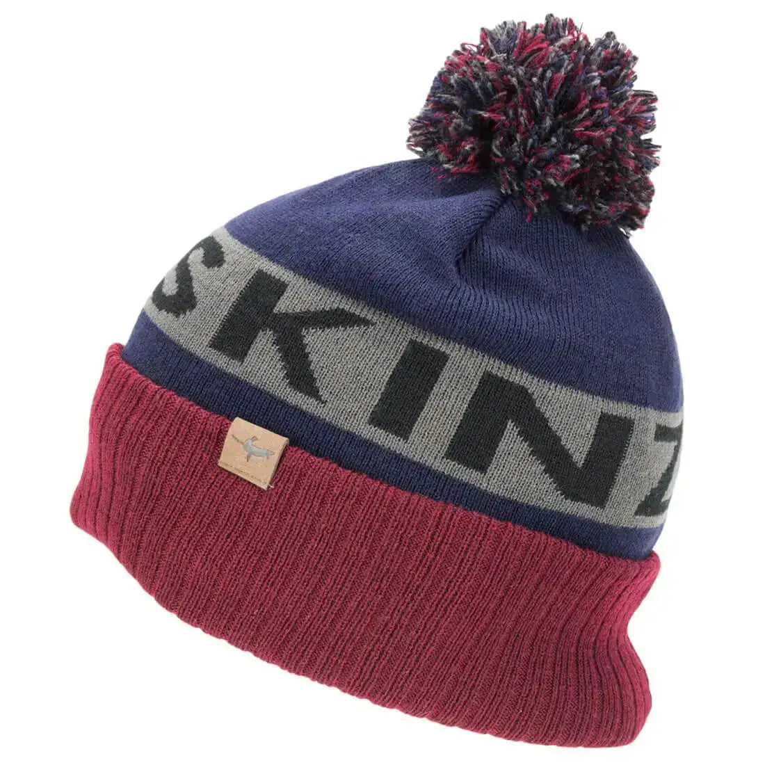 Sealskinz Foulden Water Repellent Cold Weather Bobble Beanie in navy and burgundy, offering a stylish and insulated design for winter wear. Blue from  John Bull Clothing 