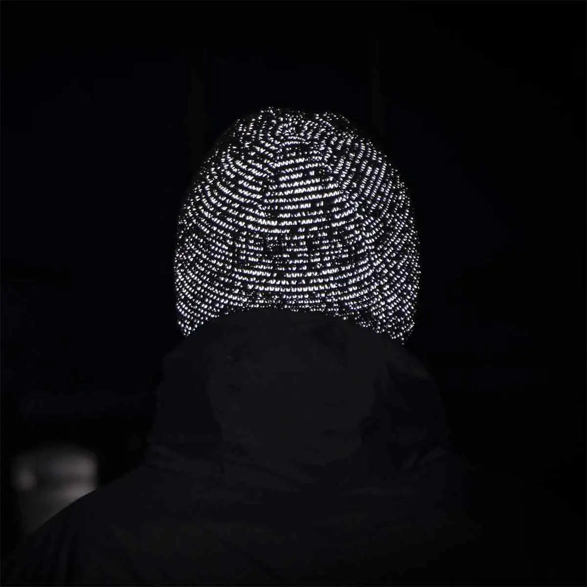 Sealskinz Waterproof Cold Weather Reflective Beanie Hat glowing in the dark due to reflective stitching. Ideal for visibility during night runs or cycling.  from  John Bull Clothing 